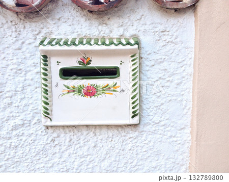 Traditional ceramic mailbox on white wall in Tenerife. Spanish craftsmanship, folk art, and Mediterranean heritage reflecting island identity. 132789800