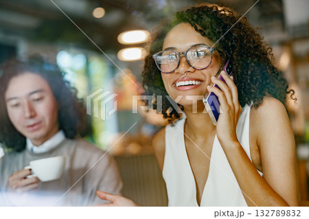 casual cafe interaction, authentic snapshot of remote work life with cheerful coworkers in hip casual cafe interaction, authentic snapshot of remote work life with cheerful coworkers in hip 132789832