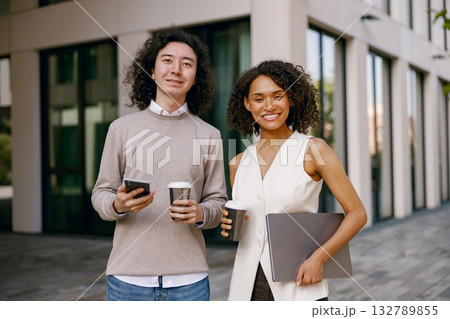 modern corporate setting showcasing professionals socializing with gadgets amid urban landscape modern corporate setting showcasing professionals socializing with gadgets amid urban landscape 132789855