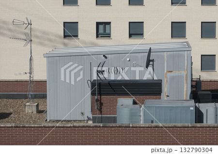 Antennas installed on the roof of a residential building. Concept of communication. Antennas installed on the roof of a residential building. Concept of communication. 132790304
