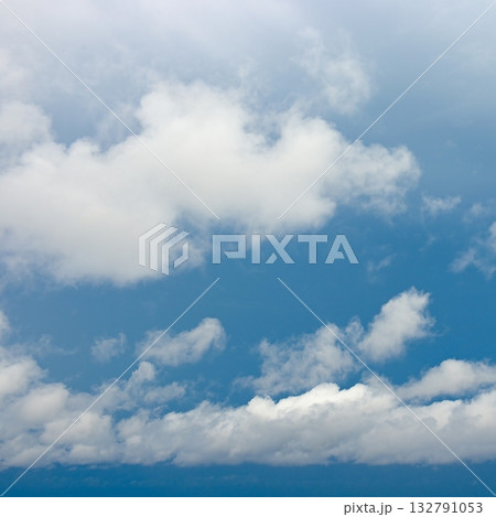 Fluffy White Clouds on a Sunny Day with Clear Blue Sky 132791053