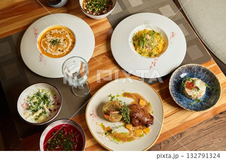 Delicious Artisanal Dishes Presented Beautifully on a Wooden Table for Everyone to Enjoy 132791324