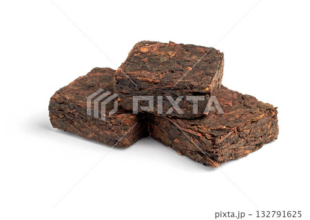 Three pieces of pressed fermented black tea isolated on white background. Three pieces of pressed fermented black tea isolated on white background. 132791625