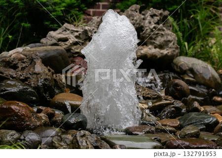 A small fountain made of stones made by man A small fountain made of stones made by man 132791953