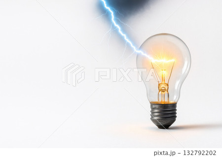 Lightning hits a burning bulb. Space for text. 132792202