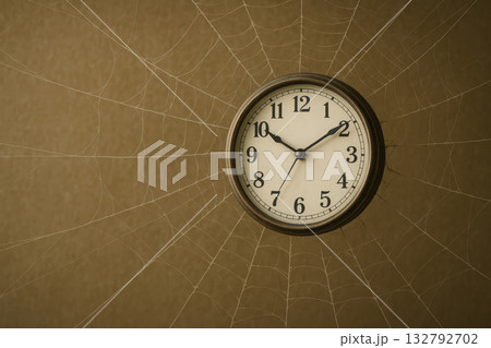 Wall clock covered with cobwebs. Space for text. 132792702