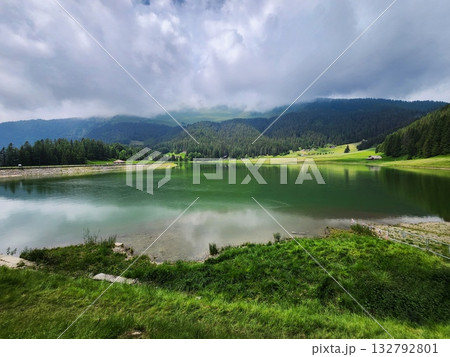Alpine Lake Meadow under Stormy Clouds 132792801