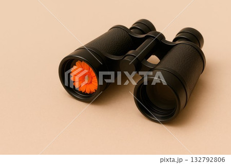 Binoculars with a flower inside the lens. Space for text. 132792806