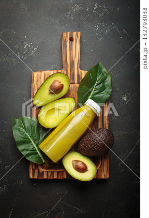 Avocado smoothie fresh fruit halves dark background cutting board healthy drink diet nutrition Avocado smoothie fresh fruit halves dark background cutting board healthy drink diet nutrition 132793038