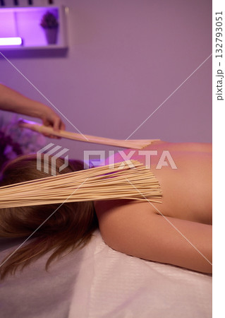 Experience relaxation and muscle relief with a spa treatment using bamboo sticks for rejuvenation 132793051