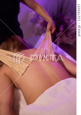 Experience relaxation and muscle relief with a spa treatment using bamboo sticks for rejuvenation Experience relaxation and muscle relief with a spa treatment using bamboo sticks for rejuvenation 132793057