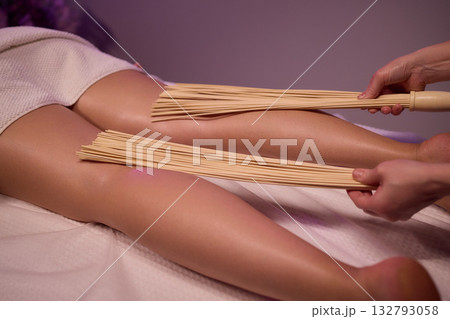 Experience relaxation and muscle relief with a spa treatment using bamboo sticks for rejuvenation Experience relaxation and muscle relief with a spa treatment using bamboo sticks for rejuvenation 132793058