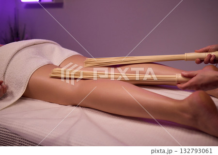Experience relaxation and muscle relief with a spa treatment using bamboo sticks for rejuvenation 132793061