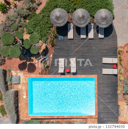 Chic outdoor leisure scene, Stylish sunlit terrace with pools and umbrellas, Luxurious Mediterraneaninspired pool area with relaxing loungers and decorative plants Chic outdoor leisure scene, Stylish sunlit terrace with pools and umbrellas, Luxurious Mediterraneaninspired pool area with relaxing loungers and decorative plants 132794030