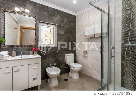 Elegant spa suite, Refined bathing area with stylish design and tranquil ambiance, Opulent restroom space boasting contemporary elements and calming atmosphere for guests 132794053