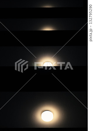 Symmetrical wall lights in modern architectural space 132795290