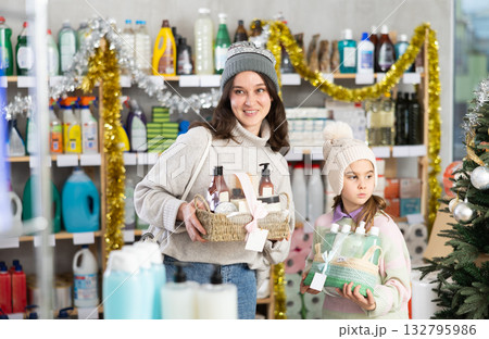 Woman with child family select and studies label present, consist of bathroom cosmetics on X mas Eve Woman with child family select and studies label present, consist of bathroom cosmetics on X mas Eve 132795986