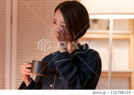 夜、部屋でテレビを見てくつろぐパジャマの女性 132796154