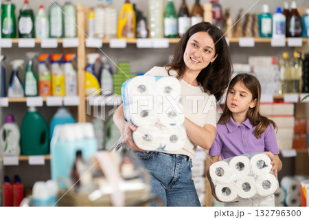 Woman with daughter choosing toilet paper in store 132796300