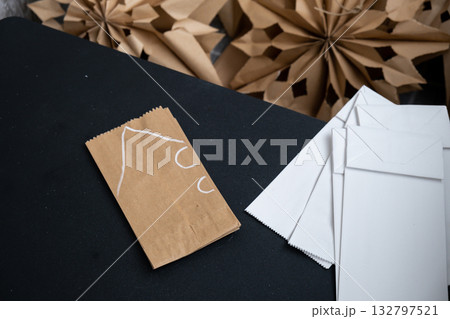 Sustainableminded Christmas cozy home handmade decoration. Tutorial for making do it yourself craft paper lunch bags and hot glue. Seasonal activity for kids. 3D snowflakes eve preparation 132797521