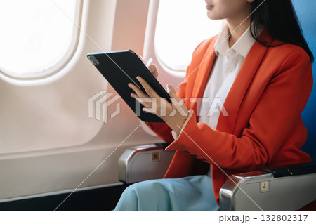 Business woman sitting front tablet ,laptop computer with financial graphs and statistics on monitor Business woman sitting front tablet ,laptop computer with financial graphs and statistics on monitor 132802317