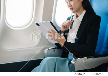 Business woman sitting front tablet ,laptop computer with financial graphs and statistics on monitor Business woman sitting front tablet ,laptop computer with financial graphs and statistics on monitor 132802488