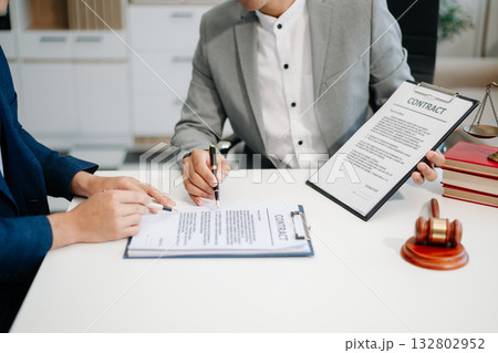 Asian business team and lawyers discussing contract papers sitting at the table. Concepts of law, advice, legal services. Asian business team and lawyers discussing contract papers sitting at the table. Concepts of law, advice, legal services. 132802952