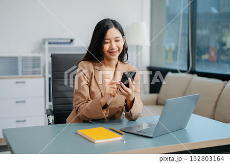 Confident business expert attractive smiling young woman holding digital tablet on desk in office. Confident business expert attractive smiling young woman holding digital tablet on desk in office. 132803164
