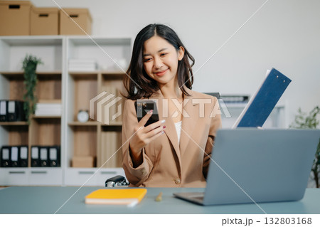 Confident business expert attractive smiling young woman holding digital tablet  on desk in office. 132803168