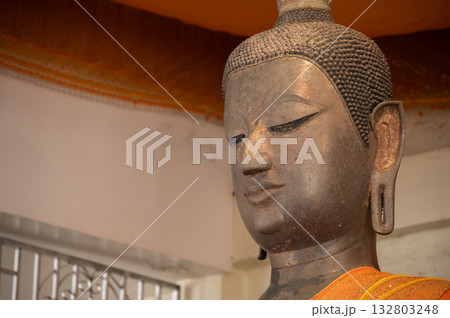 An ancient bronze Buddha statue after discovery and dig it up from island on Mekong river. This Buddha situated at Wat Thong Thip Pattanaram, Laos. An ancient bronze Buddha statue after discovery and dig it up from island on Mekong river. This Buddha situated at Wat Thong Thip Pattanaram, Laos. 132803248