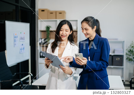 Businesswoman leading team meeting and using tablet and laptop computer with financial in co working Businesswoman leading team meeting and using tablet and laptop computer with financial in co working 132803327