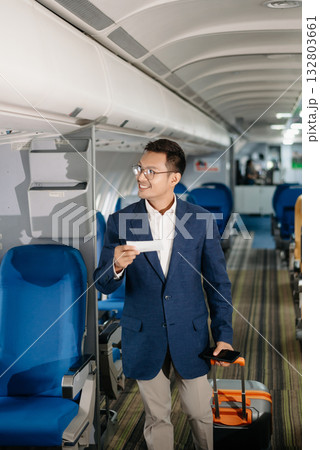 Young Asian executive excels in first class, multitasking with digital tablet, laptop and smartphone. Travel in style, Young Asian executive excels in first class, multitasking with digital tablet, laptop and smartphone. Travel in style, 132803661