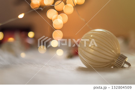 Clean christmas bauble on white wool with bokeh lights background 132804509