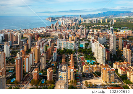 Panoramic view of Benidorm, a famous resort city in Spain, featuring its iconic skyline, shimmering sea, and modern architecture along the coast. Beautiful sunny Mediterranean scenery. 132805656