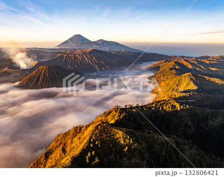 Aerial view Mountains at Bromo volcano during sunrise sky,Beautiful Mountains Penanjakan in Bromo Tengger Semeru National Park,East Java,Indonesia.Nature landscape background Aerial view Mountains at Bromo volcano during sunrise sky,Beautiful Mountains Penanjakan in Bromo Tengger Semeru National Park,East Java,Indonesia.Nature landscape background 132806421