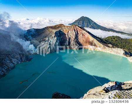Aerial view of rock cliff at Kawah Ijen volcano with turquoise sulfur water lake at sunrise.Amazing nature landscape view at East Java, Indonesia.Natural landscape colorful sky background Aerial view of rock cliff at Kawah Ijen volcano with turquoise sulfur water lake at sunrise.Amazing nature landscape view at East Java, Indonesia.Natural landscape colorful sky background 132806436
