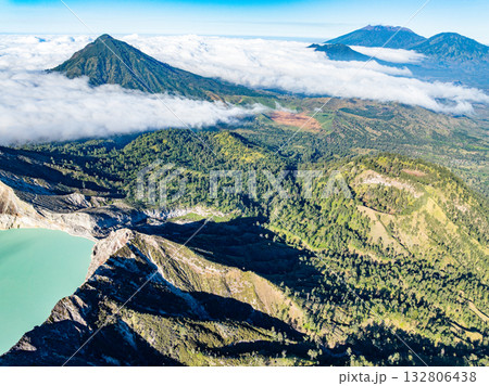 Aerial view of rock cliff at Kawah Ijen volcano with turquoise sulfur water lake at sunrise.Amazing nature landscape view at East Java, Indonesia.Natural landscape colorful sky background 132806438