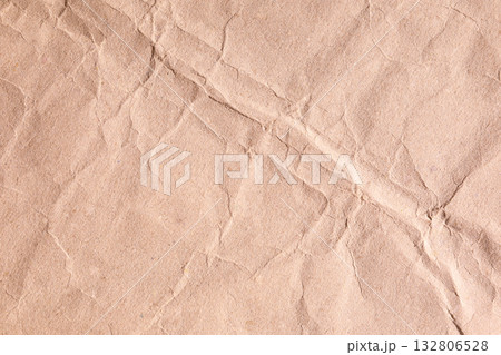Brown crumpled paper texture with diagonal creases lines 132806528