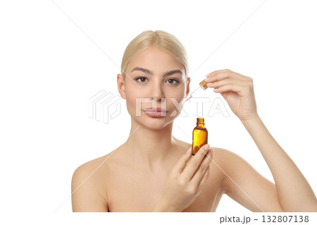 Woman readies serum in amber bottle, isolated on white, PNG 132807138