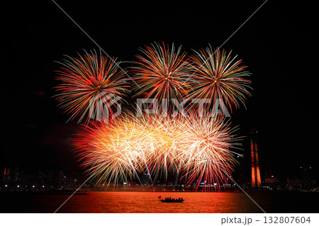 Colorful fireworks at night over the river. 132807604