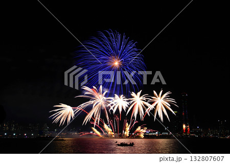 Colorful fireworks at night over the river. Colorful fireworks at night over the river. 132807607