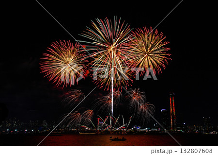 Colorful fireworks at night over the river. 132807608
