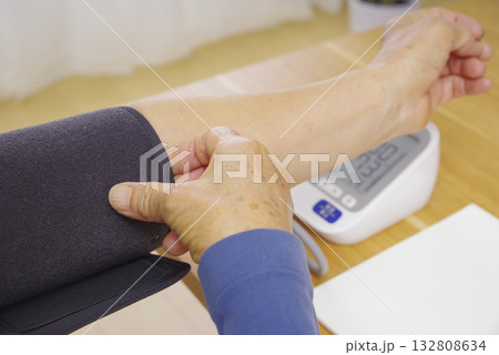 家庭用血圧計で血圧を測定する人の手元 家庭用血圧計で血圧を測定する人の手元 132808634
