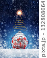 New Year's card with a ball and gifts inside in the form of a bomb on the snow, a Christmas tree wick and sparks. Festive banner with hoarfrost on night abstract defocused lights background. 132808664