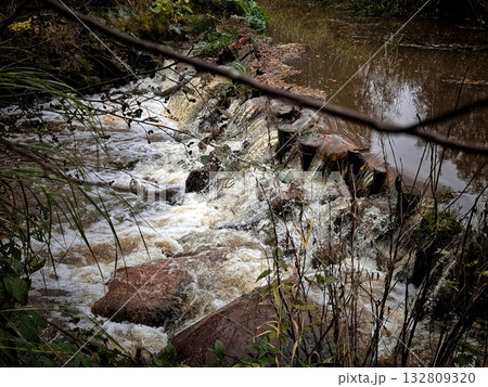 churning, foamy water on a river rapid on a bright summer day 132809320