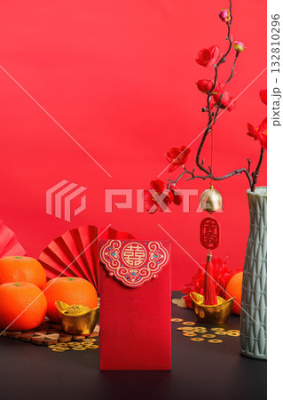 Chinese New Year red envelope with oranges and festive decorations Chinese New Year red envelope with oranges and festive decorations 132810296