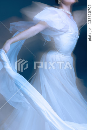 White silk gown in motion, arm extended with fluid grace and golden light White silk gown in motion, arm extended with fluid grace and golden light 132810706