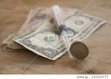euro coin with us dollar bills on wooden table currency exchange concept 132810777