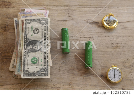 energy costs concept with batteries money and time on wooden table energy costs concept with batteries money and time on wooden table 132810782
