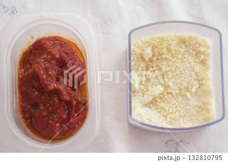 grated parmesan cheese and homemade tomato sauce 132810795